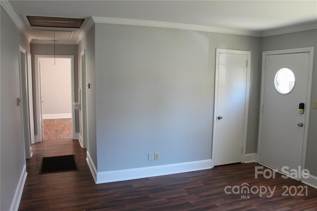 4322 Tillman Road Charlotte, NC 28208 - Photo 6 of 20 a view of an empty room with wooden floor and a window