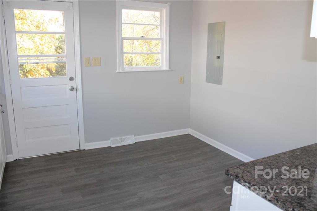 4322 Tillman Road Charlotte, NC 28208 - Photo 8 of 20 an empty room with wooden floor and windows