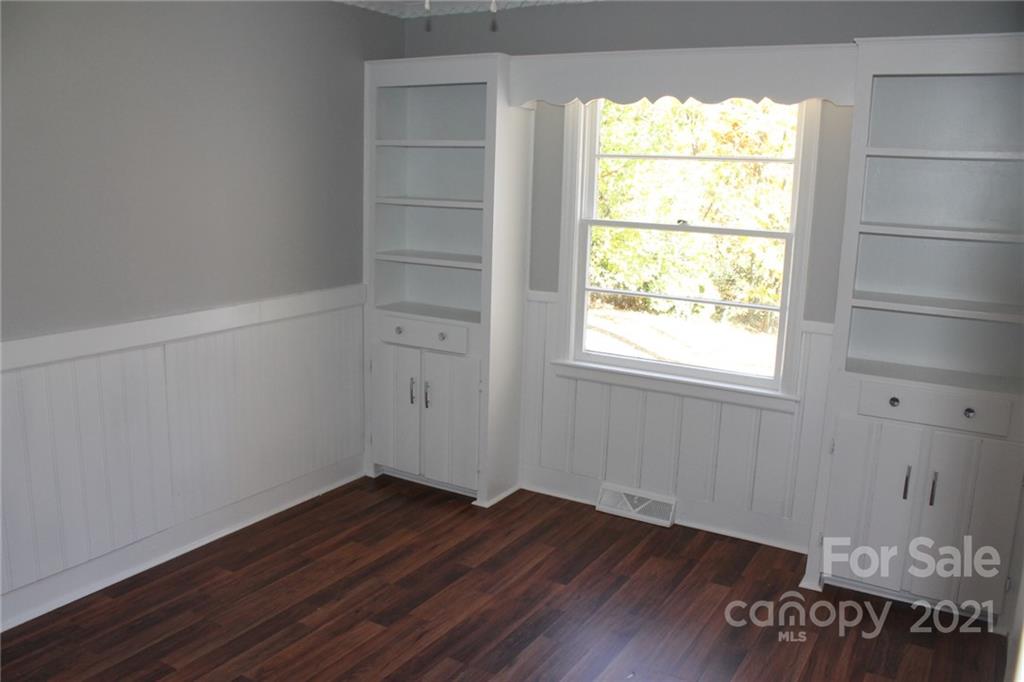 4322 Tillman Road Charlotte, NC 28208 - Photo 10 of 20 an empty room with wooden floor and windows