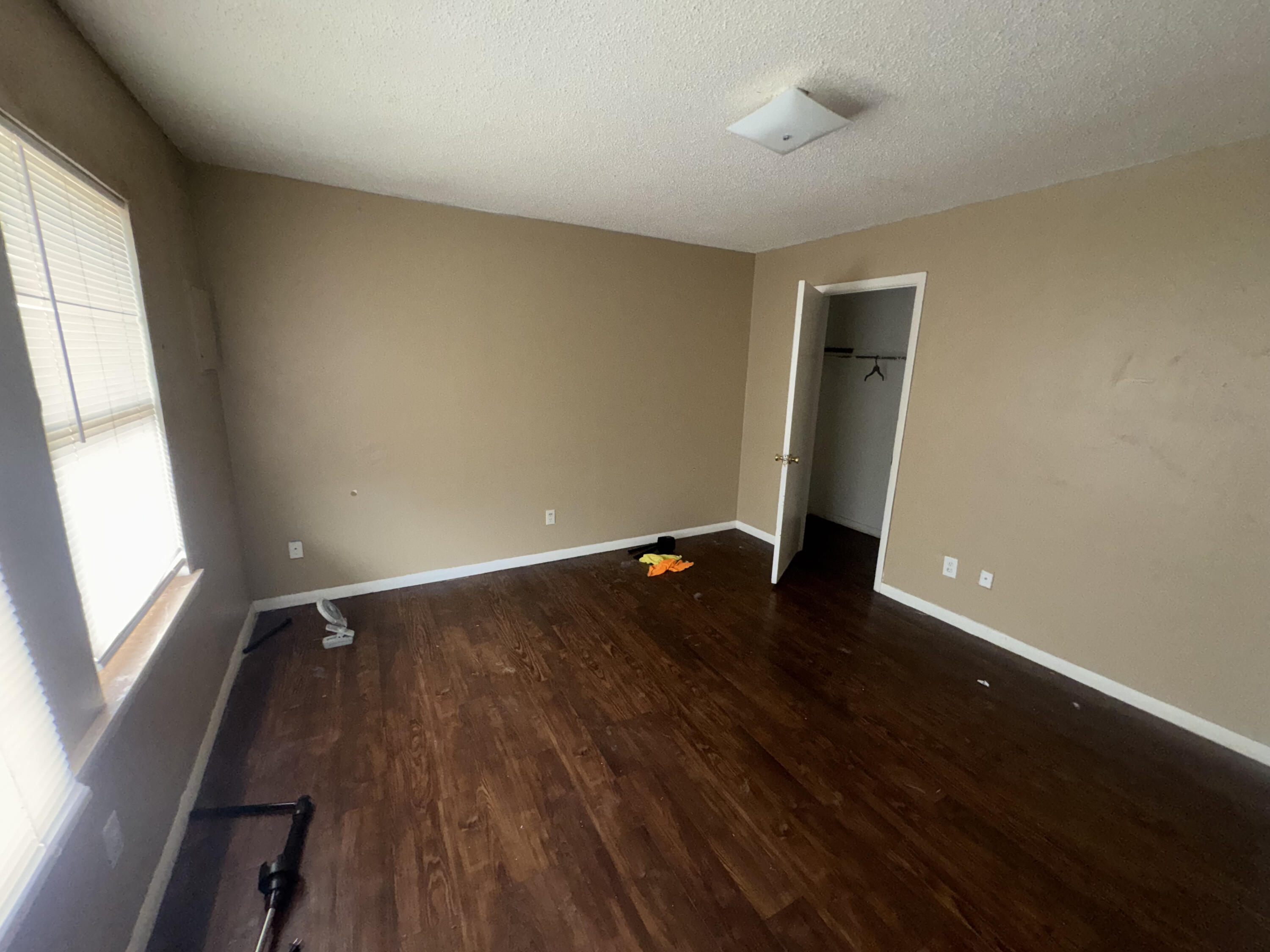 100 Pecos Place Plainview, TX 79072 - Photo 15 of 28 an empty room with wooden floor and windows