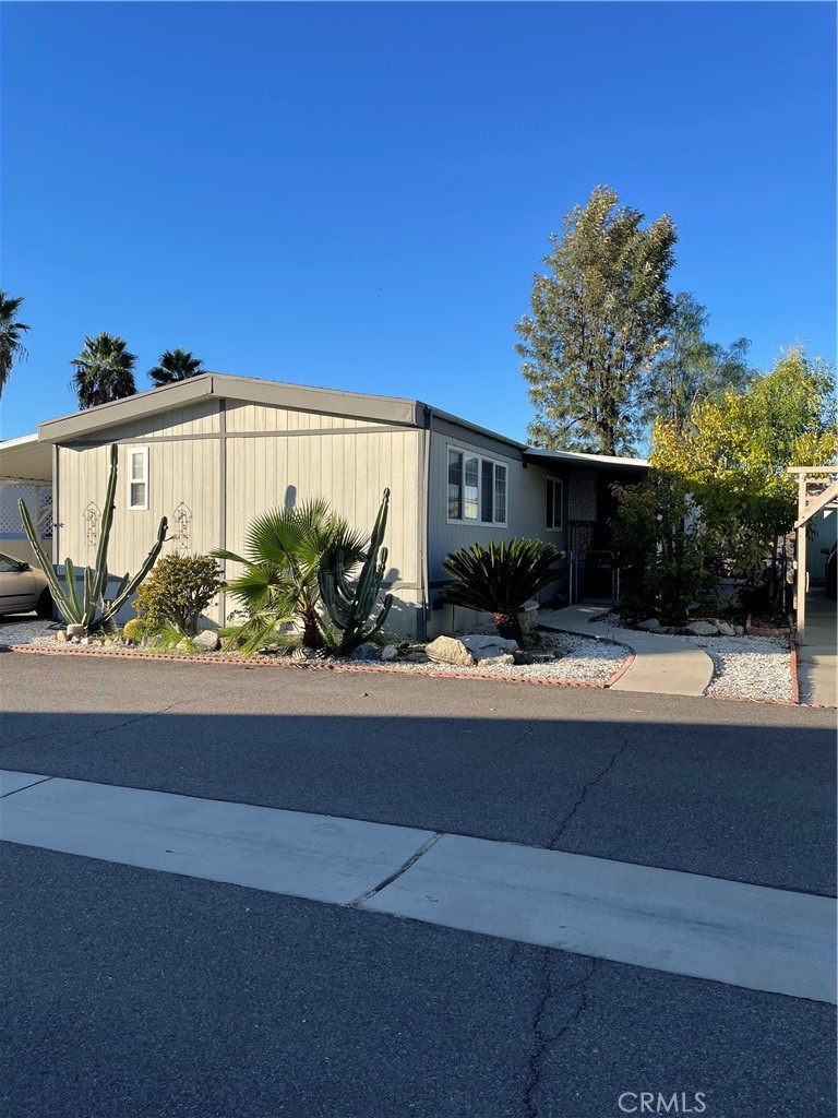 15181 Van Buren Boulevard, Unit 99 Riverside, CA 92504 - Photo 1 of 12 a house view with a outdoor space