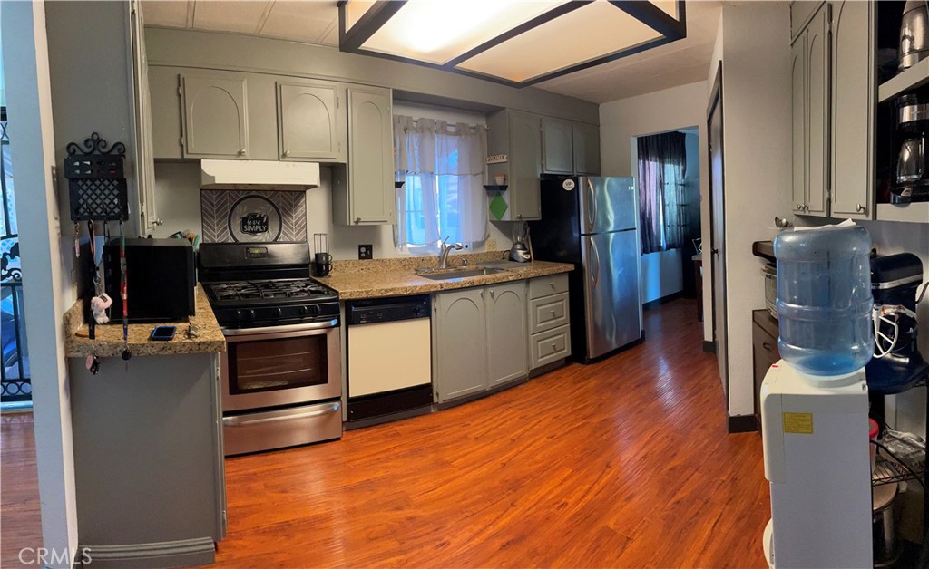 15181 Van Buren Boulevard, Unit 99 Riverside, CA 92504 - Photo 4 of 12 a kitchen with stainless steel appliances a stove a sink and a refrigerator