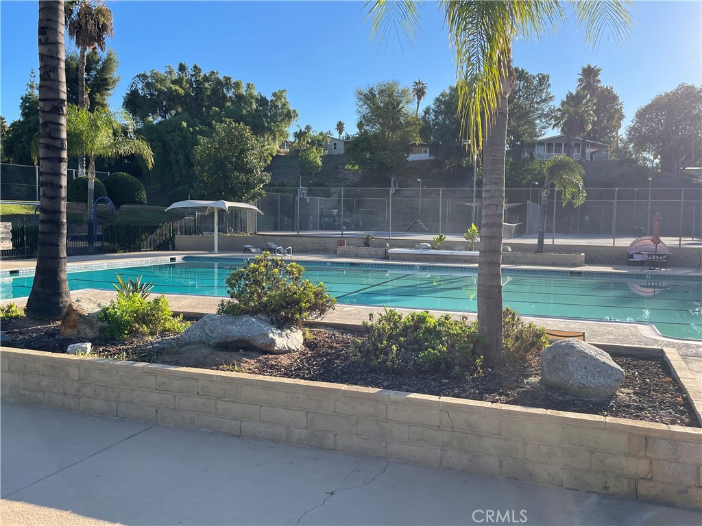 15181 Van Buren Boulevard, Unit 99 Riverside, CA 92504 - Photo 8 of 12 a view of a backyard with a garden and plants