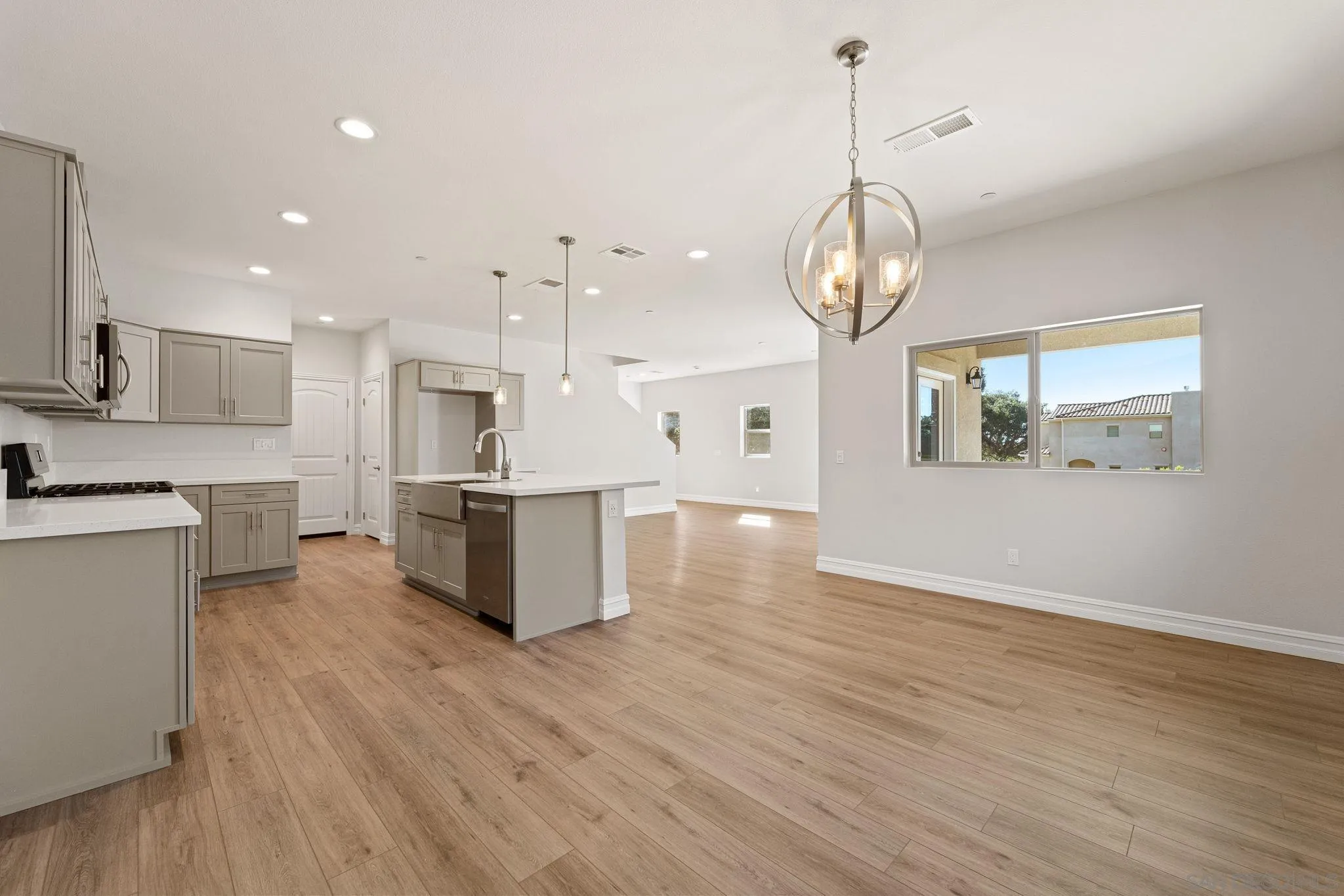 12544 Via Vigneto Lakeside, CA 92040 - Photo 4 of 30 a view of a kitchen with kitchen island stainless steel appliances microwave stove refrigerator and wooden floor