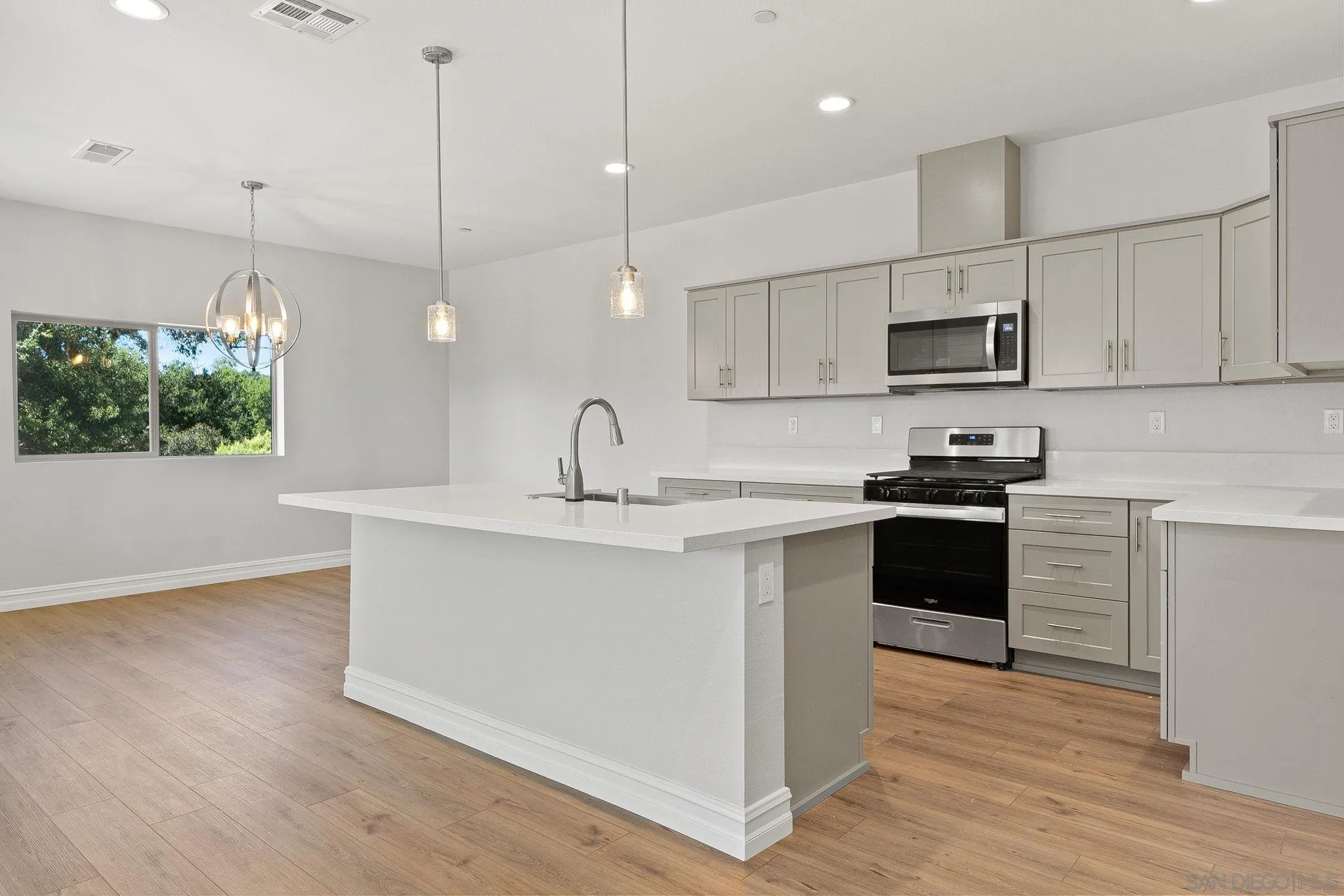 12544 Via Vigneto Lakeside, CA 92040 - Photo 5 of 30 a kitchen with stainless steel appliances granite countertop a sink a stove and a refrigerator