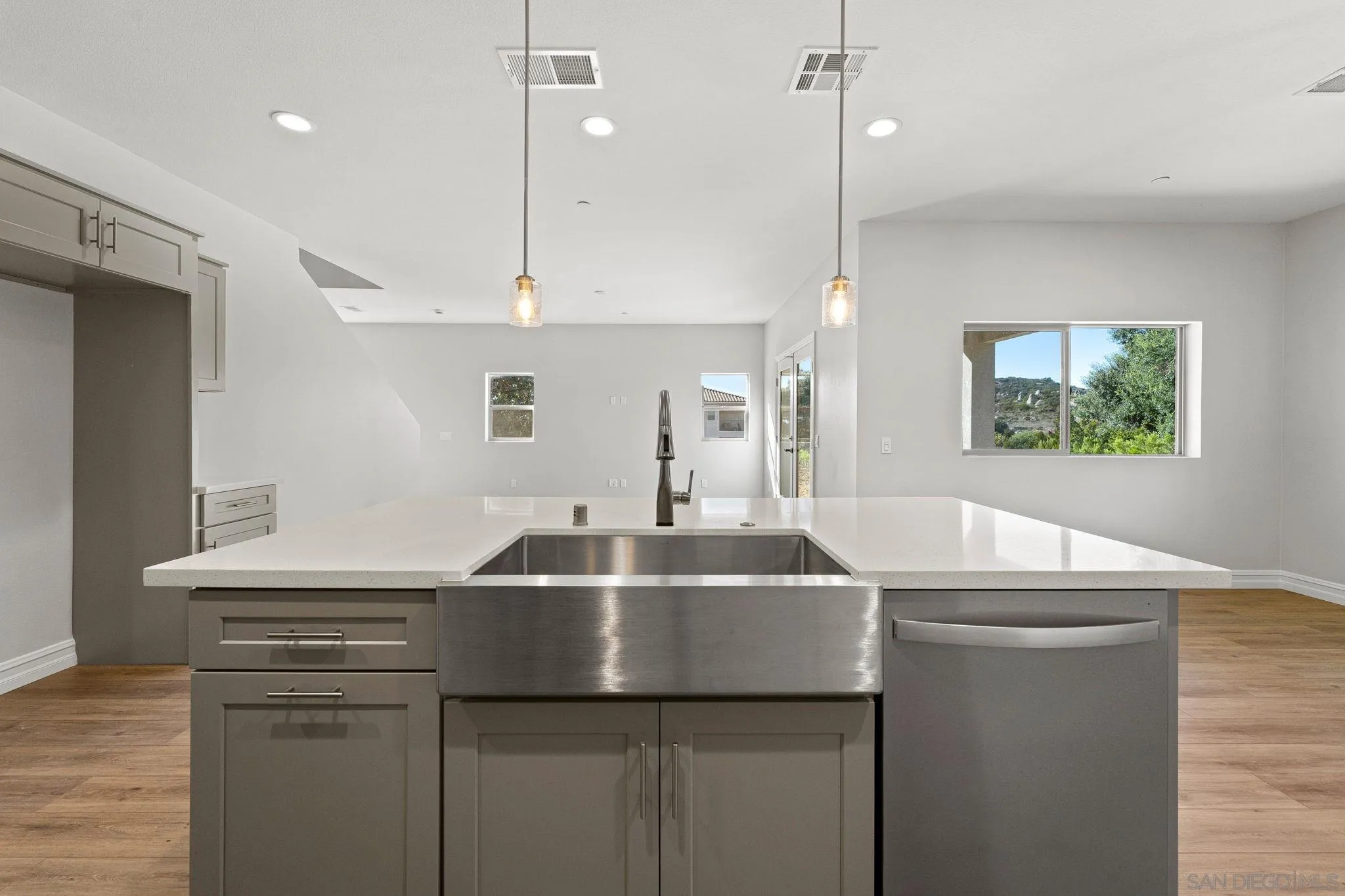 12544 Via Vigneto Lakeside, CA 92040 - Photo 7 of 30 a kitchen with kitchen island a sink appliances and a counter top space