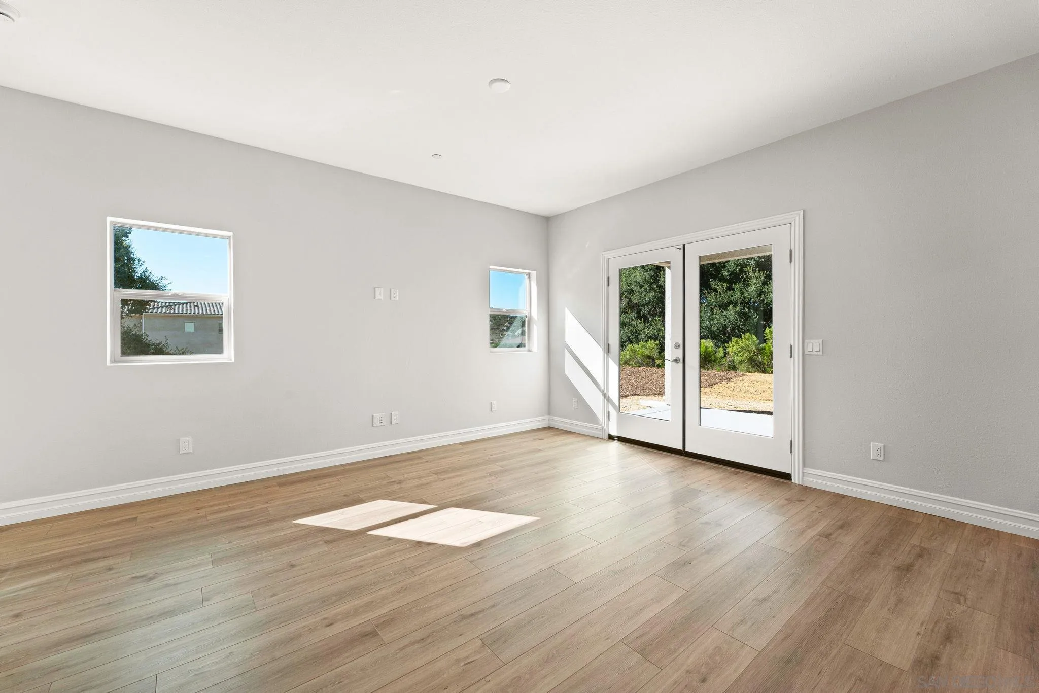 12544 Via Vigneto Lakeside, CA 92040 - Photo 10 of 30 a view of an empty room with wooden floor and a window