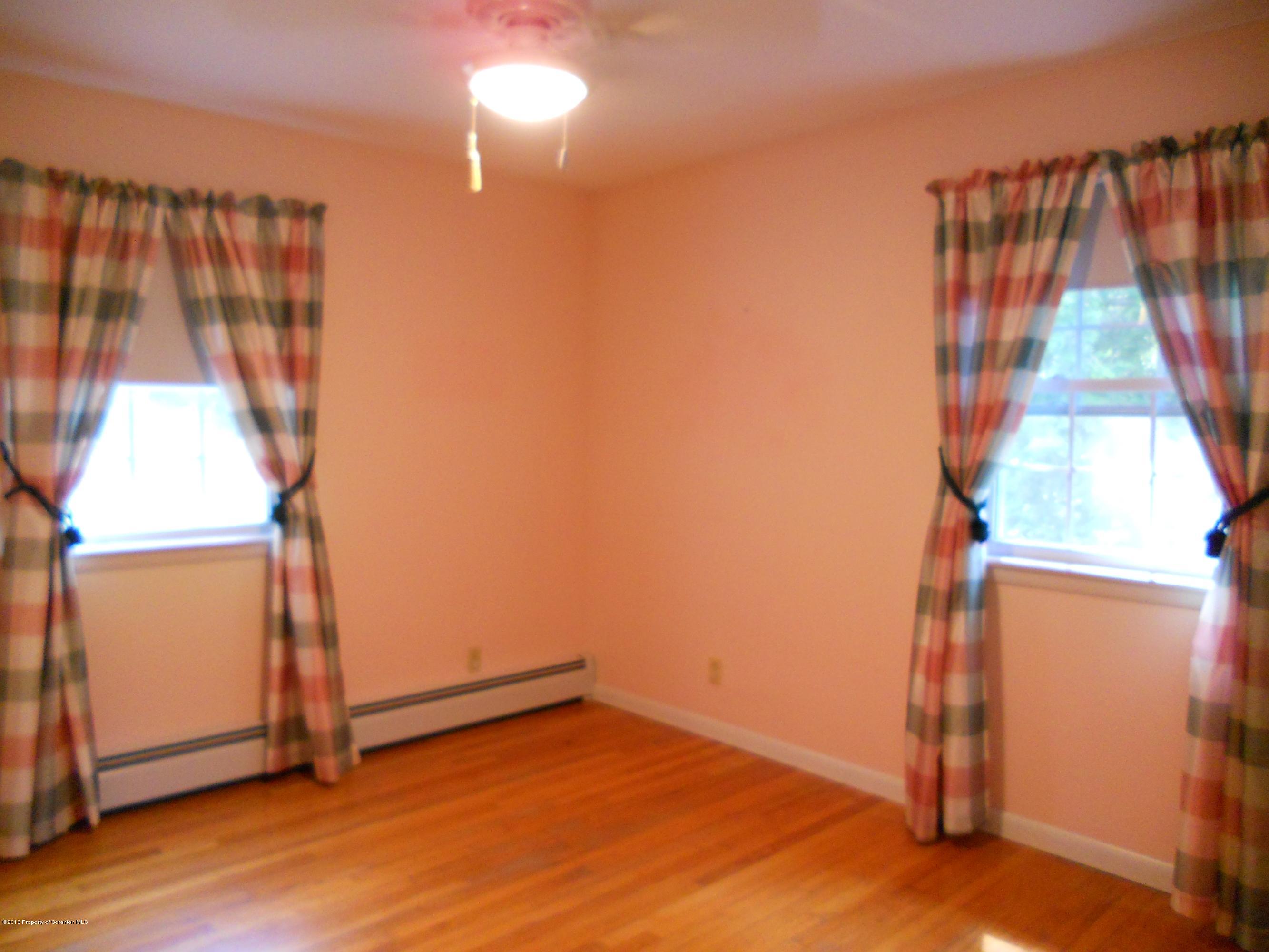 125 Fitzpatrick Road Lake Ariel, PA 18436 - Photo 39 of 61 an empty room with wooden floor and windows