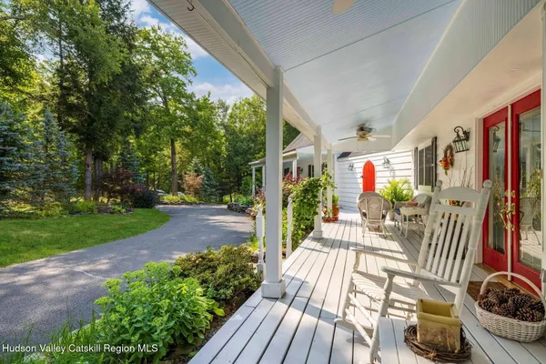 a bedroom with a large bed and a potted plant