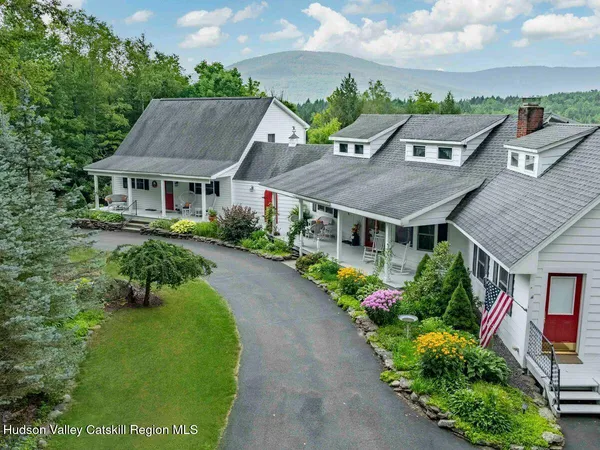 a aerial view of a house with a big yard and large trees