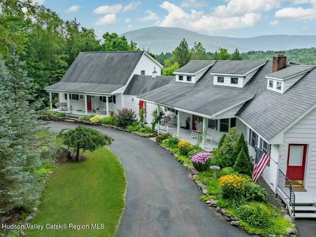a aerial view of a house with a big yard and large trees
