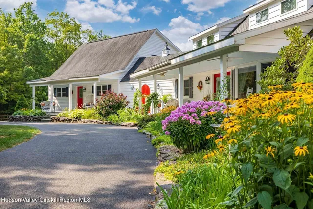 a aerial view of a house with swimming pool garden and patio