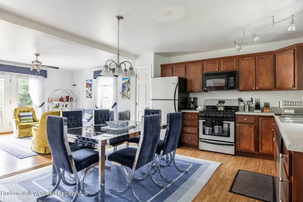 a view of a dining room with furniture and a chandelier