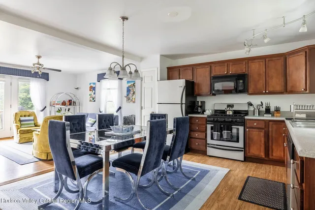 a view of a dining room with furniture and a chandelier