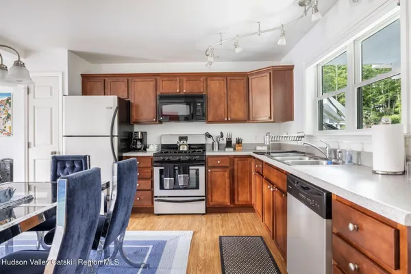 a view of a livingroom with lounge chair and a large window