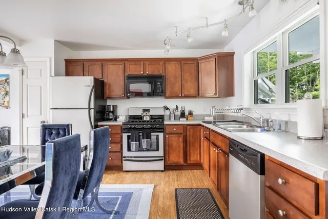a view of a livingroom with lounge chair and a large window