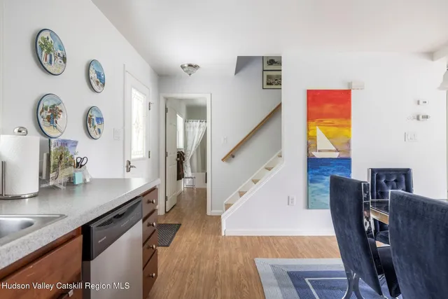 a living room with furniture fireplace and a large window