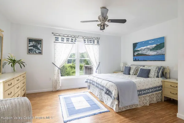 a bedroom with a bed and paintings on the wall