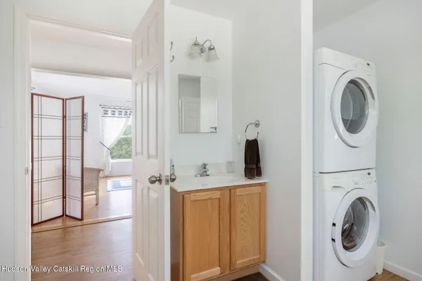 a view of a bedroom with a bed and a window