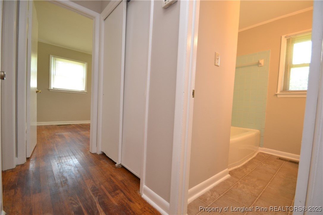 717 Friar Tuck Road Raleigh, NC 27610 - Photo 14 of 31 a view of a hallway with wooden floor