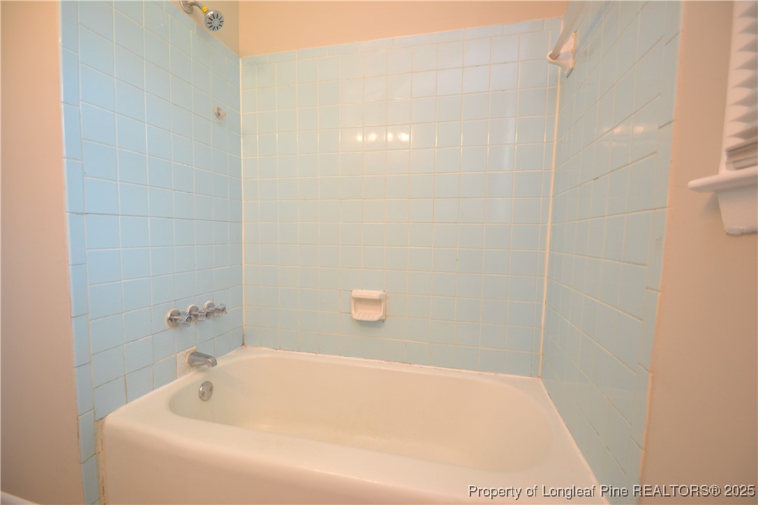 717 Friar Tuck Road Raleigh, NC 27610 - Photo 15 of 31 a bathroom with a white bath tub