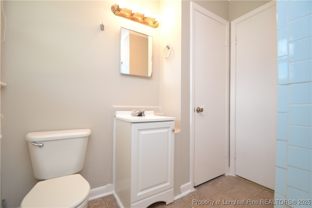 717 Friar Tuck Road Raleigh, NC 27610 - Photo 16 of 31 a white toilet sitting next to a bathroom sink
