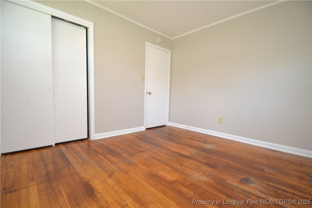 717 Friar Tuck Road Raleigh, NC 27610 - Photo 20 of 31 a view of an empty room with wooden floor