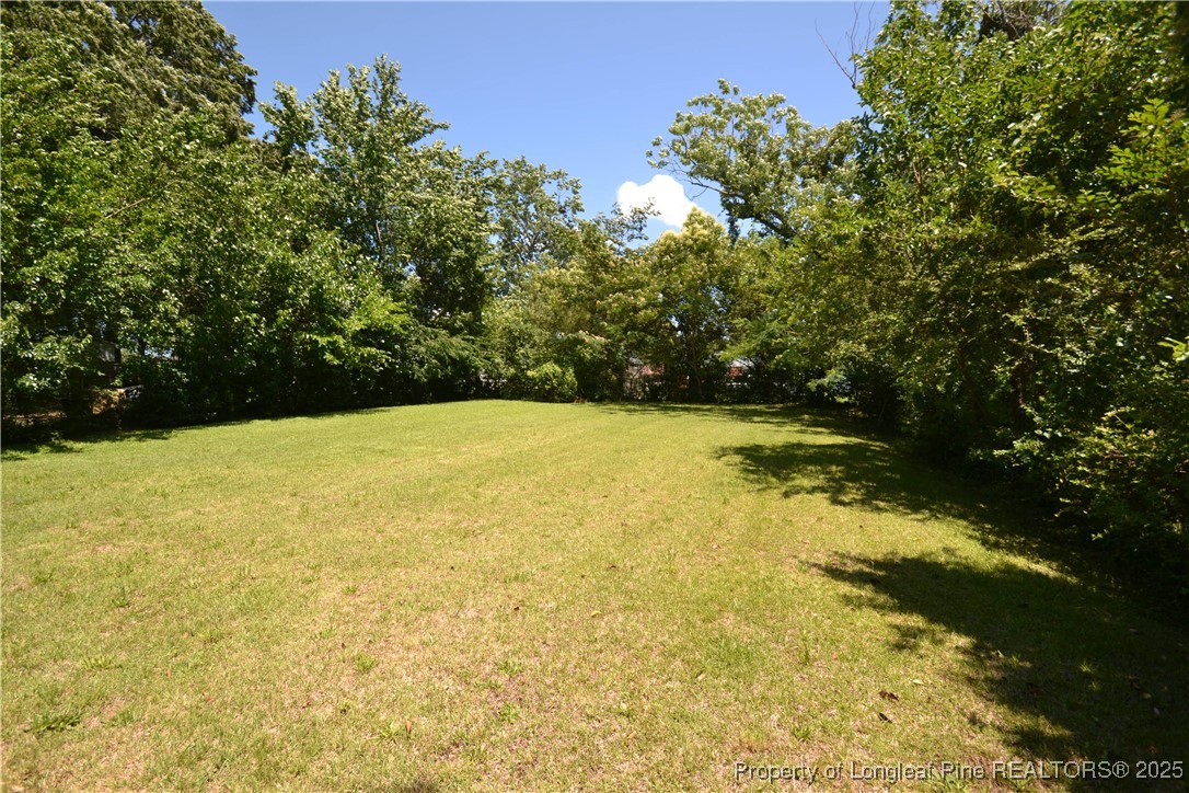 717 Friar Tuck Road Raleigh, NC 27610 - Photo 28 of 31 a view of swimming pool with an outdoor space and seating area