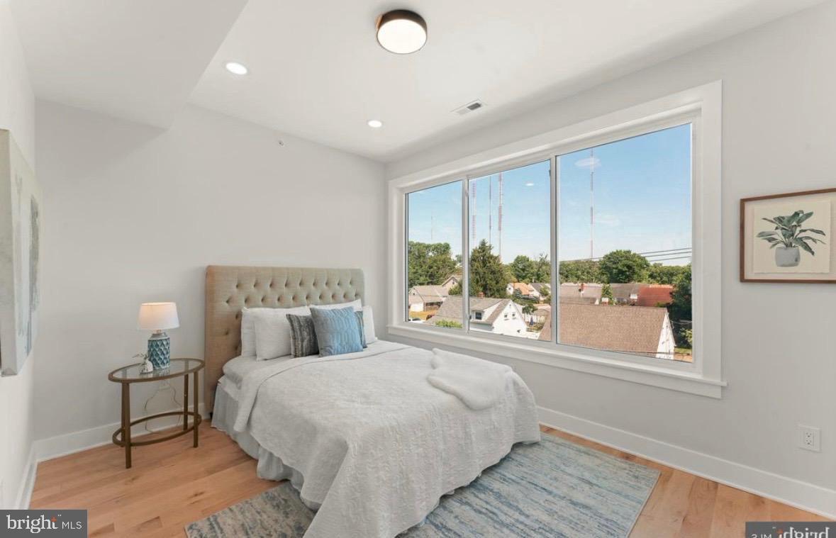 6983 Silverwood Street Philadelphia, PA 19128 - Photo 11 of 18 a bedroom with a large bed and a window