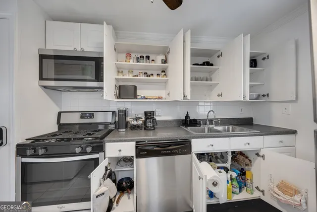 a kitchen with cabinets and steel stainless steel appliances