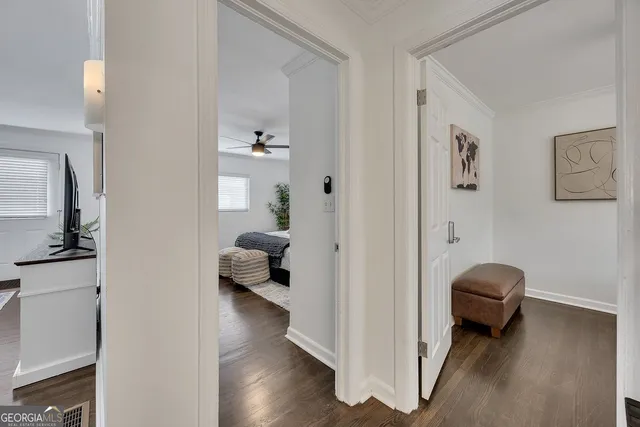 a view of a hallway with couch and wooden floor