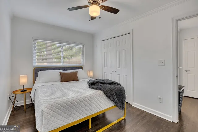 a bedroom with a bed and a window