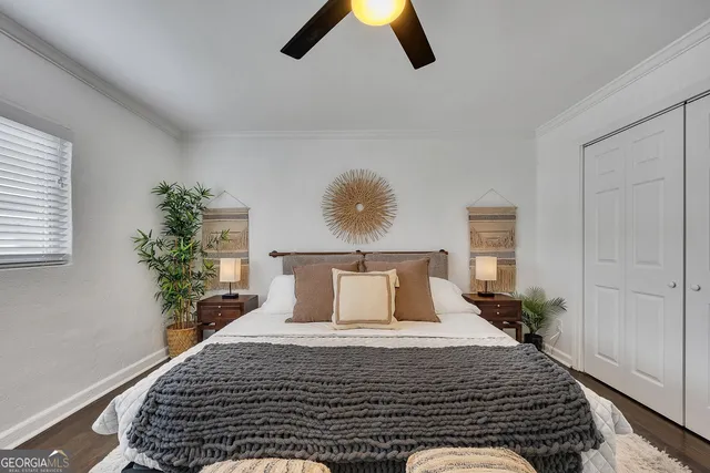 a bedroom with a bed and a potted plant