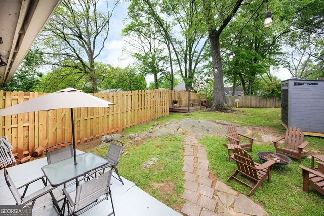 a view of backyard with a patio and outdoor seating