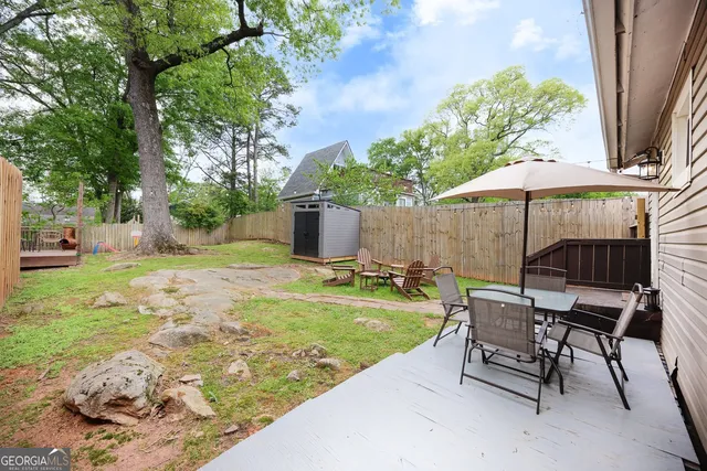 a view of a backyard with furniture and a garden