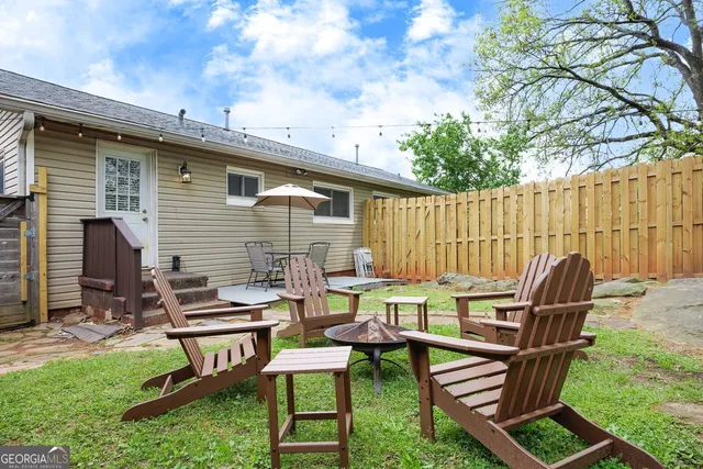 a backyard of a house with table and chairs