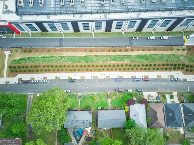 a bird view of a building with a garden and bench