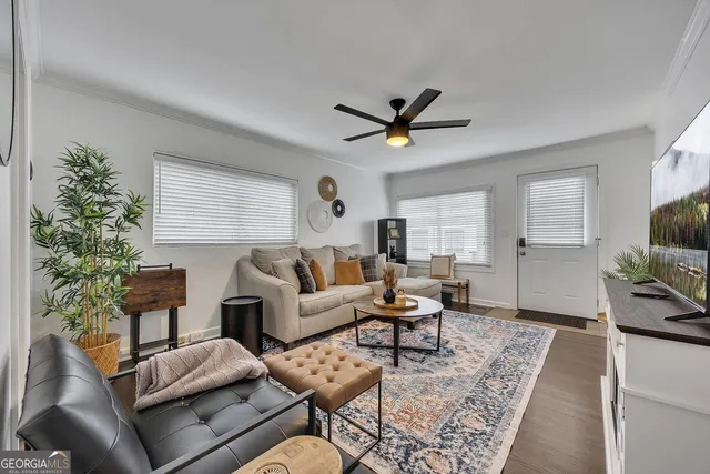 a living room with furniture and a flat screen tv