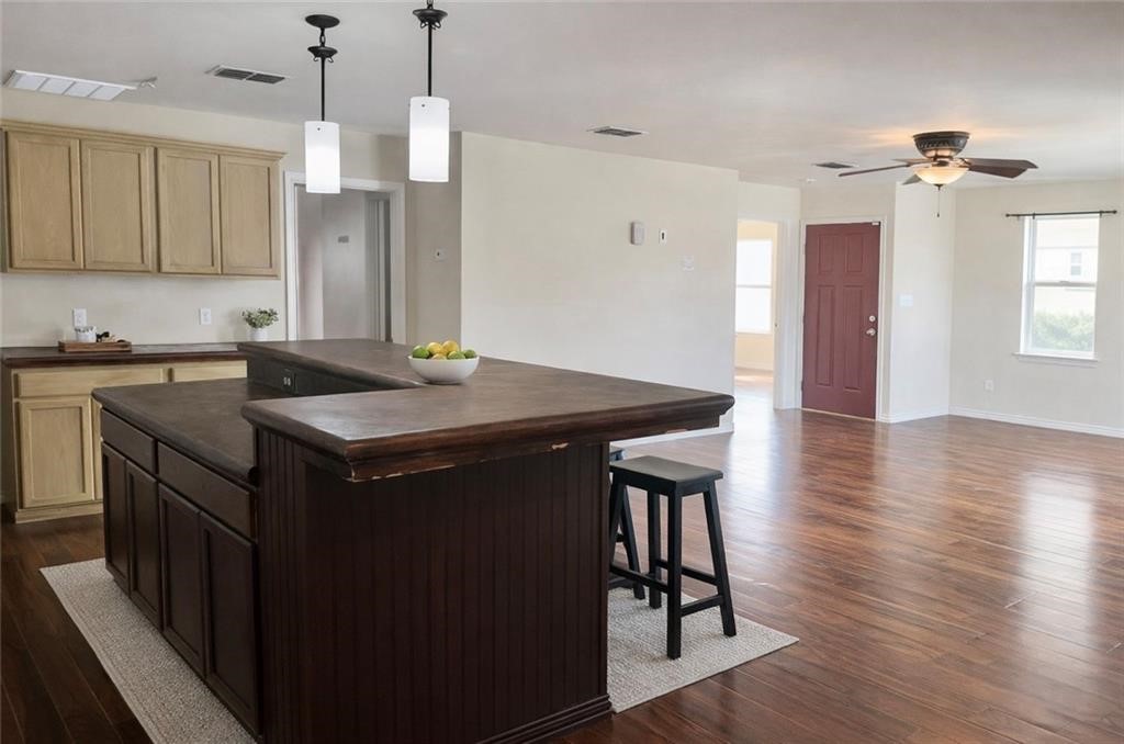 2525 Ave B Ingleside, TX 78362 - Photo 2 of 9 a kitchen with a sink a stove a refrigerator and wooden floor