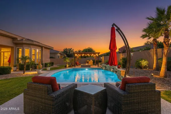 a view of swimming pool with outdoor seating and a patio