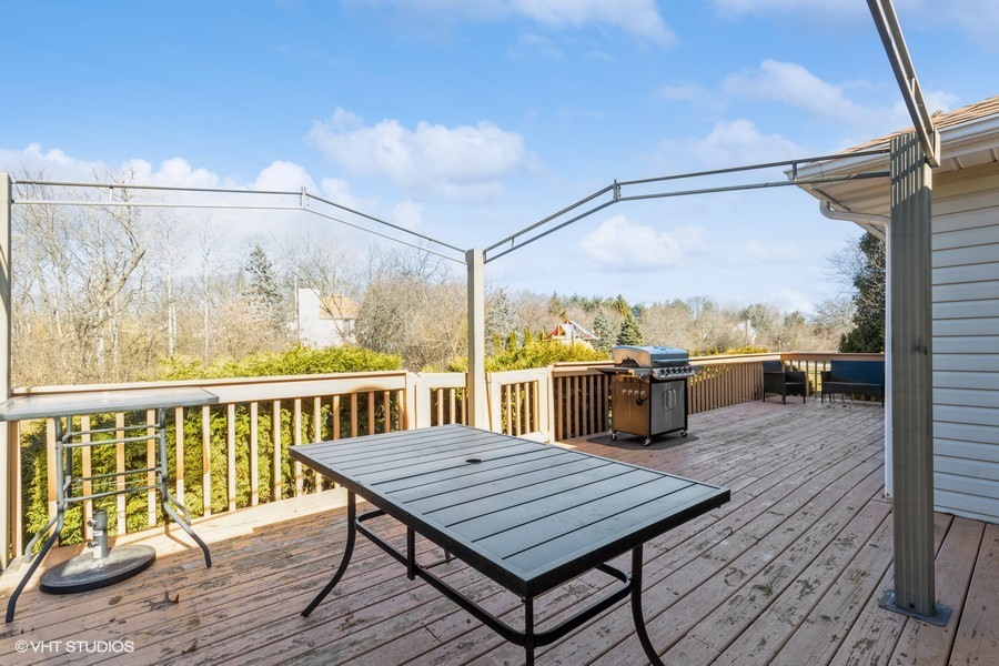 2808 Tahoe Lane Spring Grove, IL 60081 - Photo 18 of 21 a balcony with wooden floor table and chairs