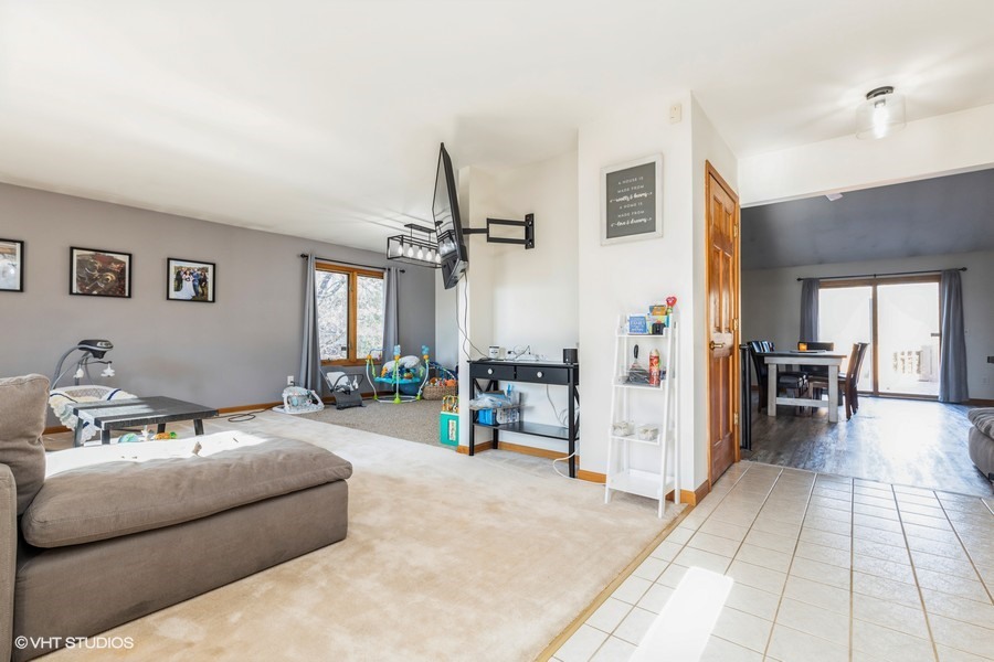 2808 Tahoe Lane Spring Grove, IL 60081 - Photo 2 of 21 a living room with furniture and a flat screen tv