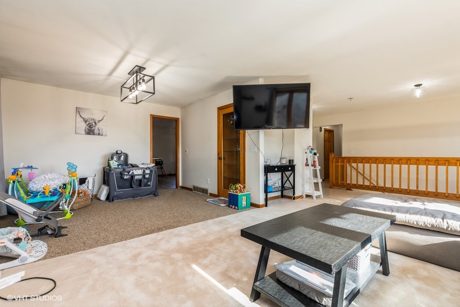 2808 Tahoe Lane Spring Grove, IL 60081 - Photo 4 of 21 a living room with furniture a pool table and a couch