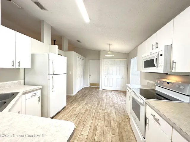 a kitchen with a refrigerator and a sink