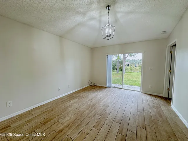 a view of room with window wooden floor and garden view