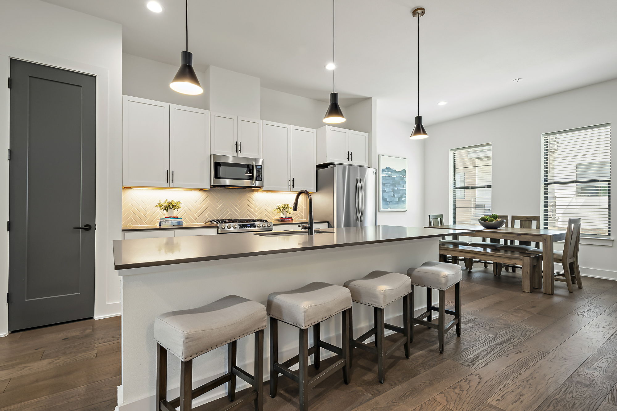 Welcoming kitchen with bar seating and spacious full dining room