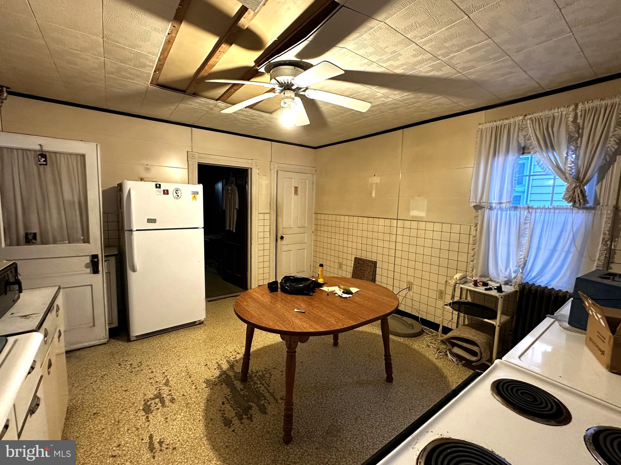 239 East Hazard Street Summit Hill, PA 18250 - Photo 11 of 39 a kitchen with a refrigerator and white appliances