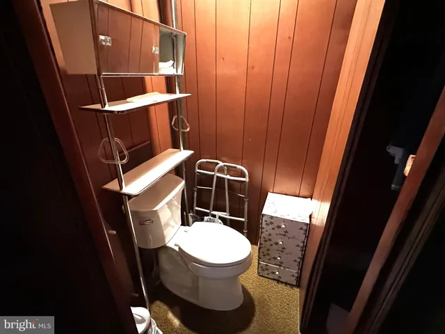 a kitchen with stainless steel appliances kitchen island granite countertop a table chairs sink and cabinets