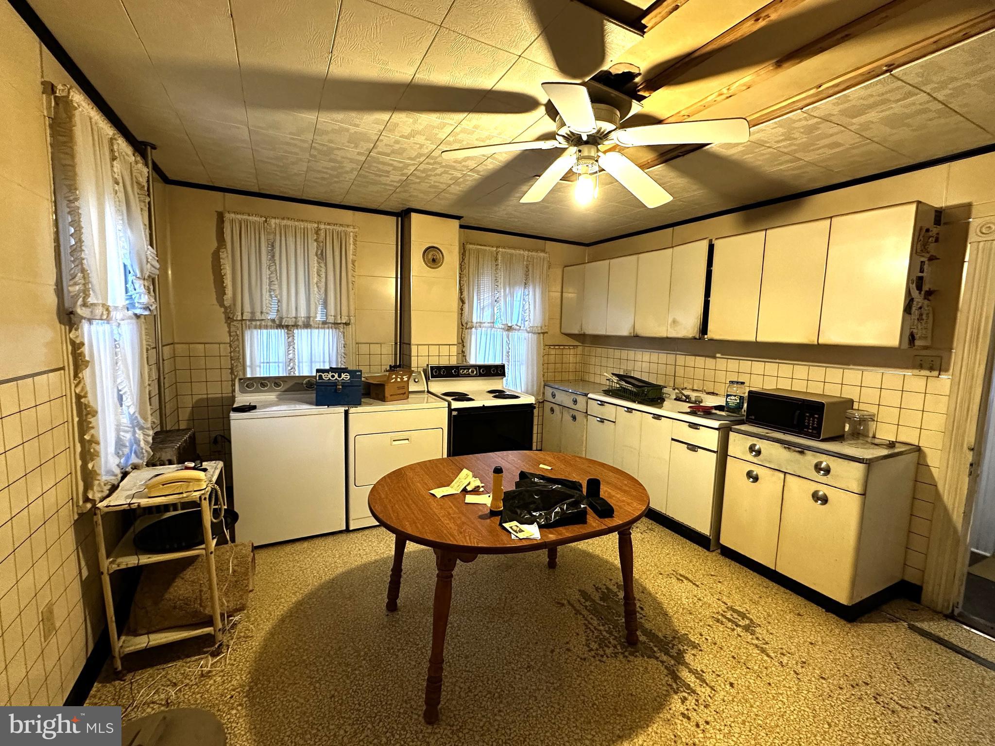 239 East Hazard Street Summit Hill, PA 18250 - Photo 9 of 39 a kitchen with stainless steel appliances kitchen island granite countertop a table chairs sink and cabinets