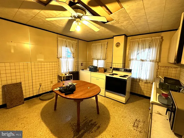 a kitchen with a refrigerator and white appliances
